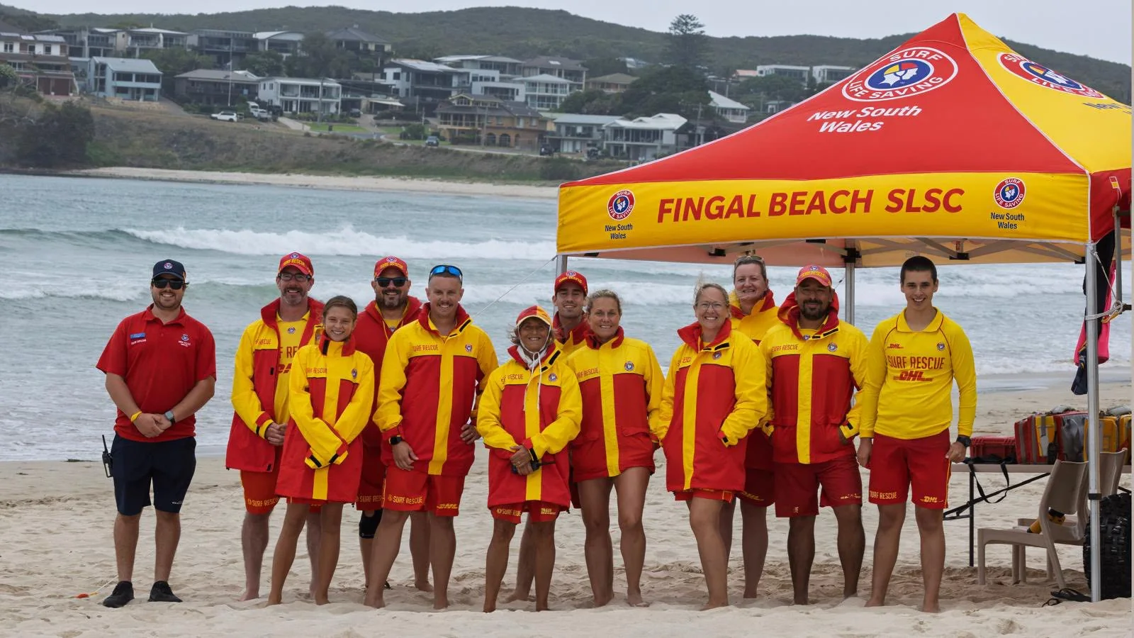 Fingal Beach SLSC volunteer patrol team at the red and yellow patrol tent on Fingal Beach