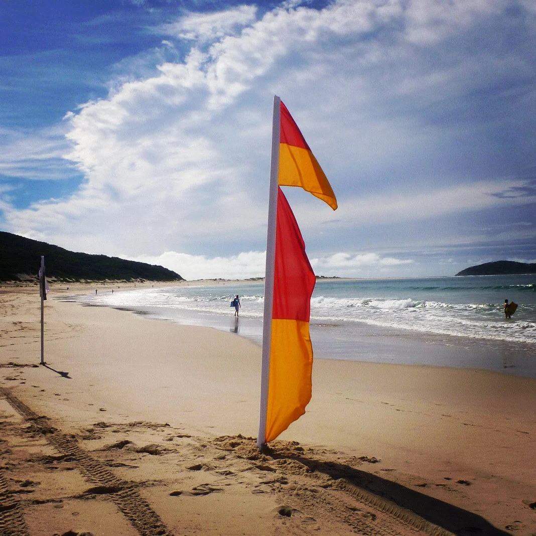 Fingal Beach red and yellow patrol flag with two separate red-and-yellow fabric sections on the pole