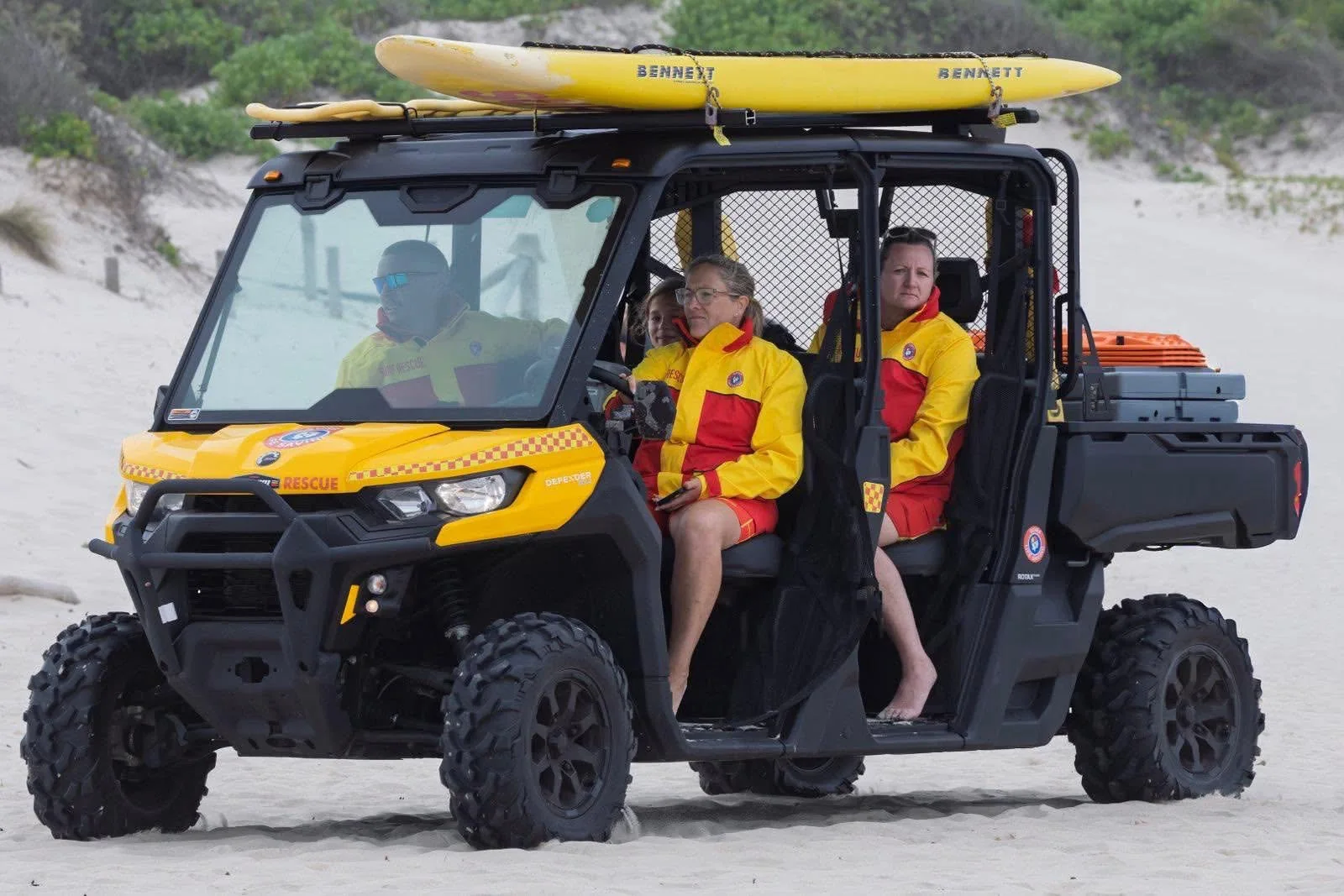 Fingal Beach Surf Life Saving Club patrol vehicle carrying rescue boards on the beach