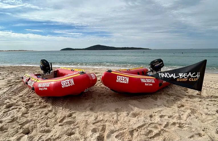 Two Fingal Beach SLSC inflatable rescue boats on the sand at Fingal Beach